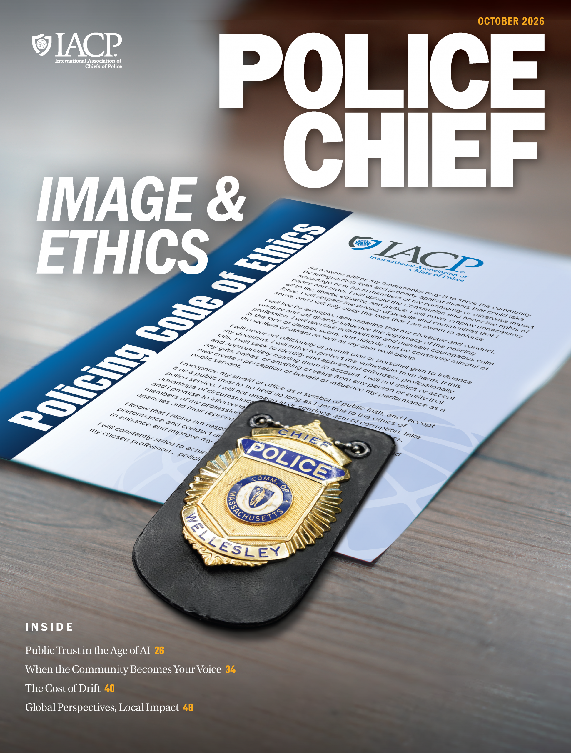 Police Chief magazine cover with a Wellesley, Massachusetts, chief police badge resting on the IACP Policing Code of Ethics on a wooden table