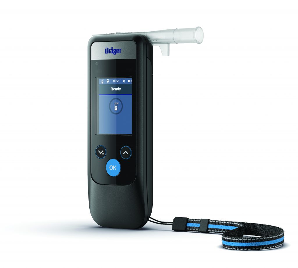 Dräger breathalyzer with mouthpiece, digital display reading 'Ready,' control buttons, and wrist strap; device used for field sobriety testing