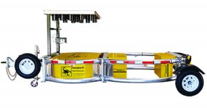 Scorpion II crash attenuator trailer with yellow/black safety markings, red/white reflective tape, two large wheels, and side-mounted spare tire.