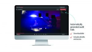 Computer monitor displaying SecureRedact interface with paused video of police car scene, download button highlighted, and text noting audit trail features