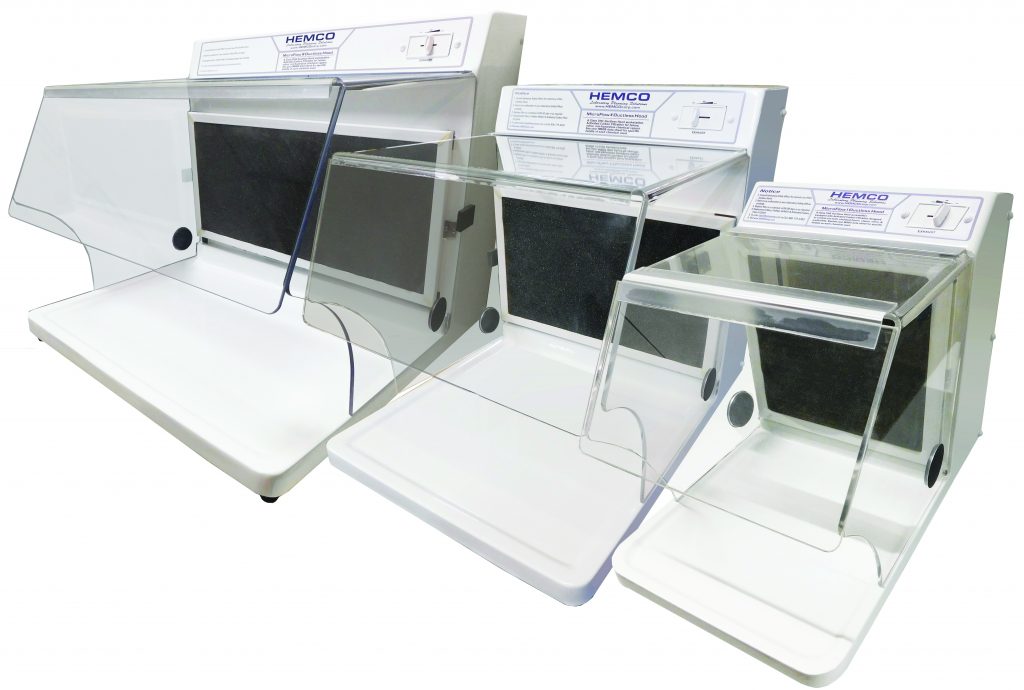 Three clear acrylic ductless laboratory workstations of varying sizes sit side by side, each with filters, control panels, and white work surfaces se