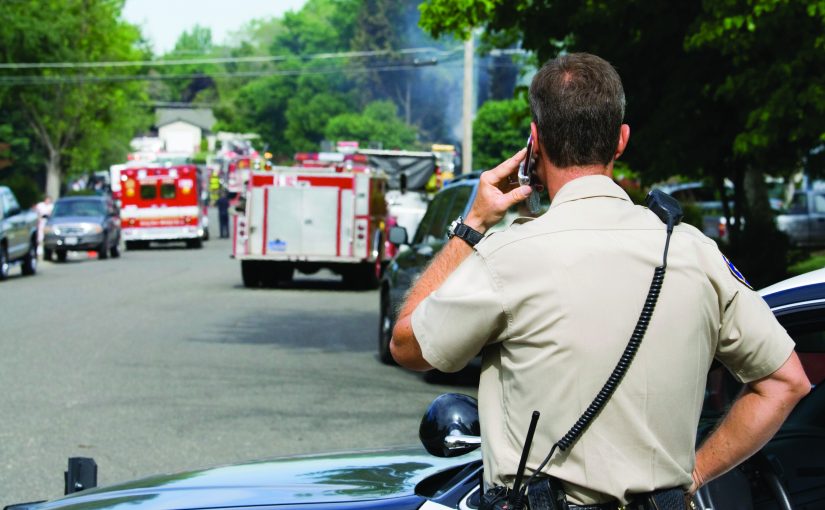 Officer on phone at scene of emergency