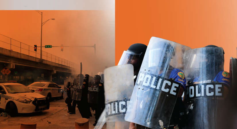 Officers in riot gear with 'POLICE' shields stand in formation; smoky scene, police cars, and overpass visible in tense urban background