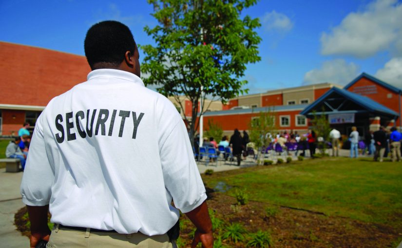 Security guard at a public junior high school -- students in background