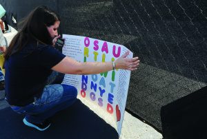 A woman leave a sign for the victims of the Pulse Nightclub shooting at the front of the nightclub building on June 21, 2016 in Orlando, Florida. 