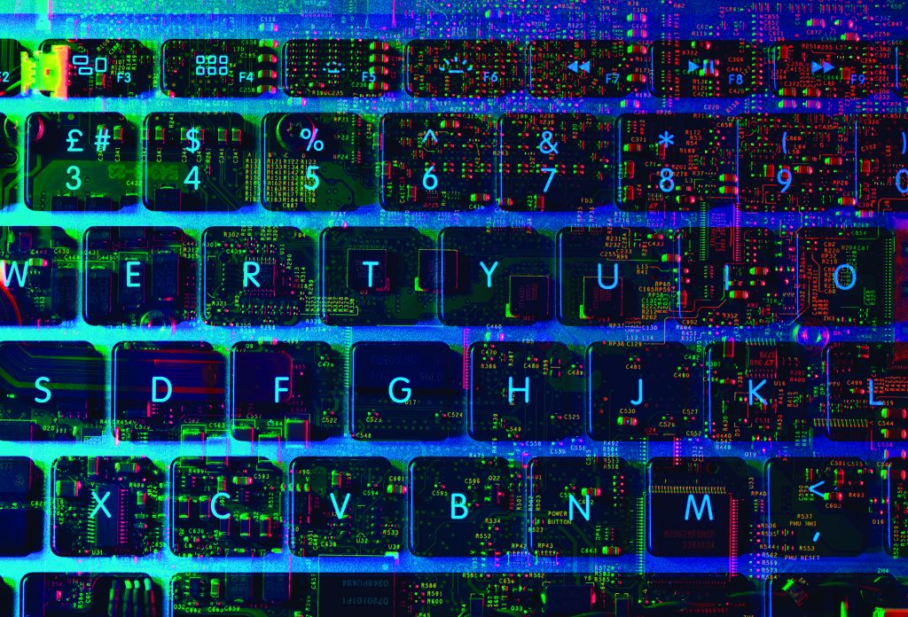 A close-up of a computer keyboard overlaid with colorful glitch-like digital patterns showing circuit imagery blended across the letter and number keys