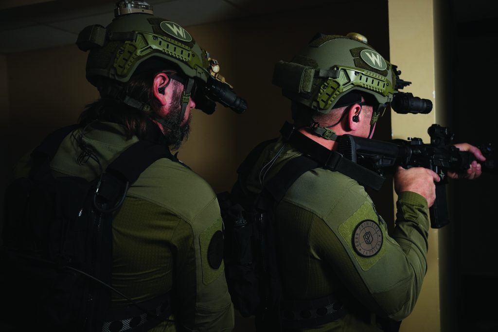 Close-up of a police officer's helmet with a reflective visor, showing the word 'POLICE' in bold letters