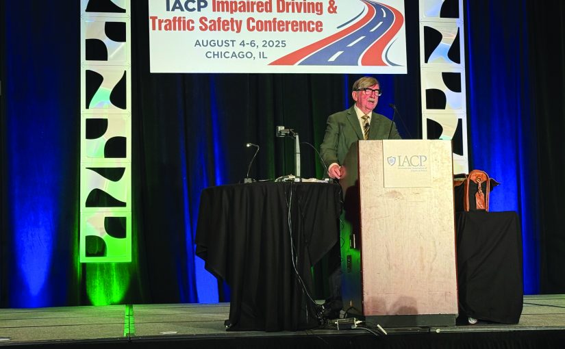 Speaker at IACP podium during Impaired Driving & Traffic Safety Conference in Chicago, Aug 4–6, 2025; event branding visible behind podium.