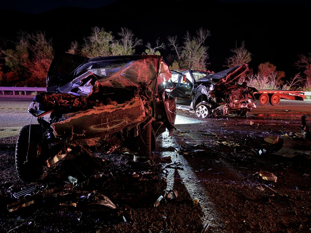 Two cars involved in a accident in the middle of the road both with major front end damage