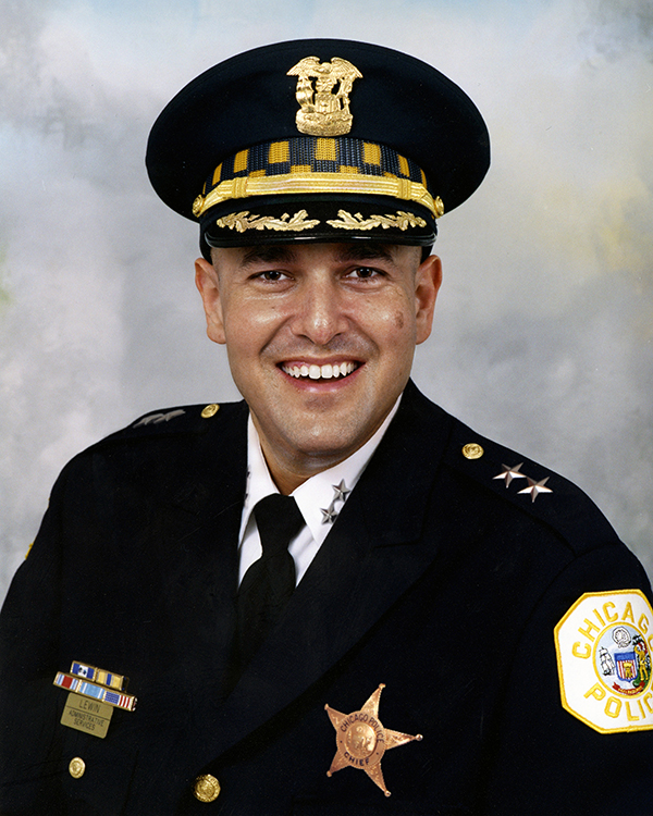 Person wearing a dark Chicago Police dress uniform with gold-trimmed peaked cap, star-shaped badge, shoulder stars, and service ribbons on chest
