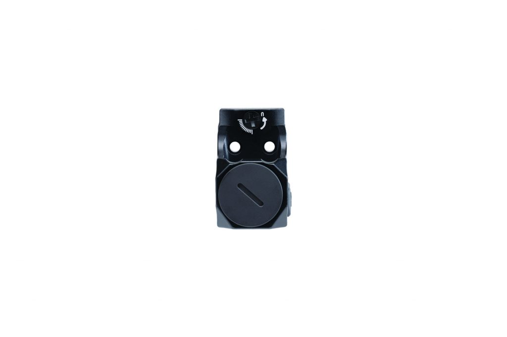 Compact black pistol sight mounted upright shows adjustment dial, windage markings, dual mounting holes, and circular housing against plain white background