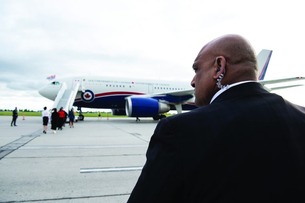 A member of the RCMP’s Protective Services surveils the tarmac as the Government of Canada plane arrives at the Canada Reception Centre at the Ottawa Macdonald-Cartier International Airport in May 2022.