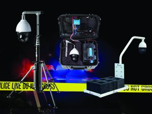 Three surveillance devices: tripod-mounted camera, open case with electronics and camera, and mounted unit on concrete blocks; police line tape behind