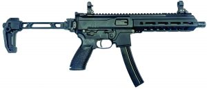 Side-profile view of a black semi-automatic pistol with extended magazine, folding brace, top rail, iron sights, ventilated handguard, and textured grip on white