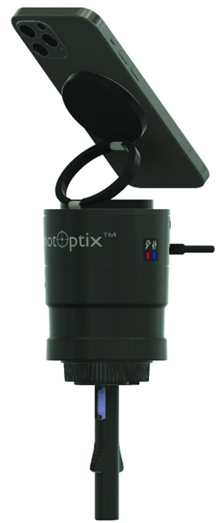 Smartphone mounted on a cylindrical ShotOptix device with a hinged ring bracket, side ports, textured adjustment ring, and attached probe extending downward