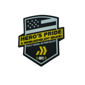 Shield-shaped Hero’s Pride patch shows a stylized U.S. flag, yellow branding, ‘Built Tough. Action Ready’ slogan, chevrons, and an NFC icon