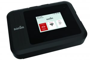 Close-up of a Sonim portable Wi-Fi hotspot device with touchscreen showing AT&T 4G MegaRange, connection status, Wi-Fi info, and menu options on display