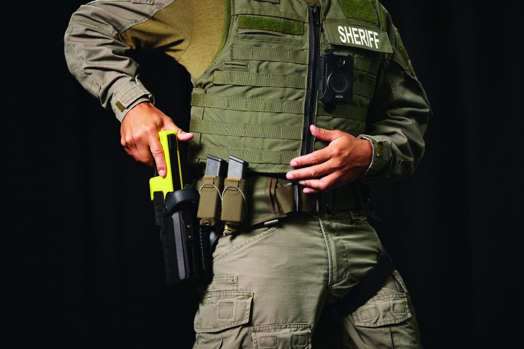 Officer grabbing their taser in the holster