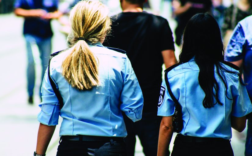 Two women police officers walking in the community